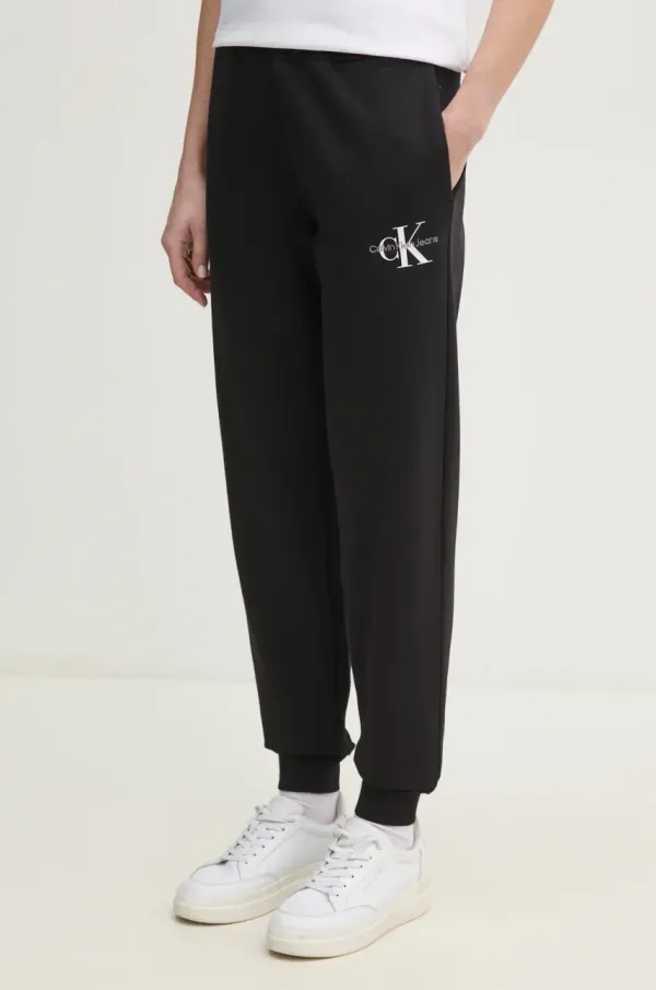 Calvin Klein Jeans Bombažen spodnji del trenirke Calvin Klein Jeans ženski, črna barva, J20J225354