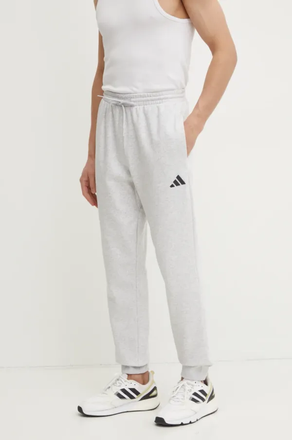 adidas Spodnji del trenirke adidas Feelcozy siva barva, JE3819