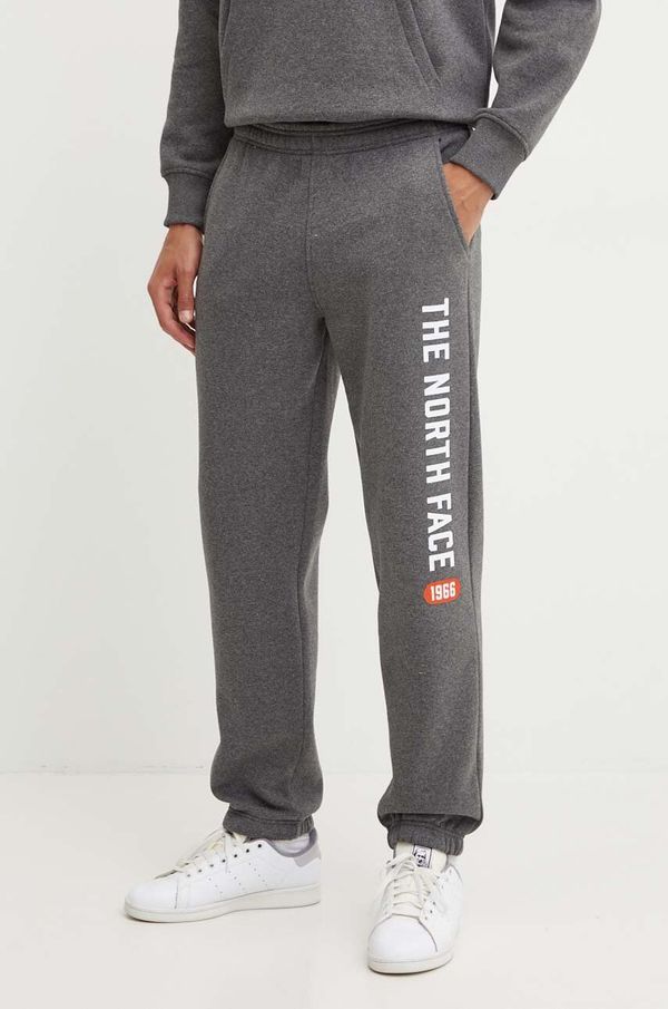 The North Face Spodnji del trenirke The North Face Pant Varsity Graphic siva barva, NF0A89DPDYY1