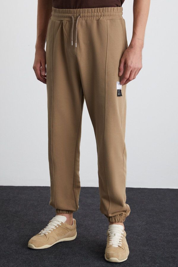 GRIMELANGE GRIMELANGE Rowan Men's Relaxed, Ribbed Front, Decorative Labeled, Mink Sweatpants