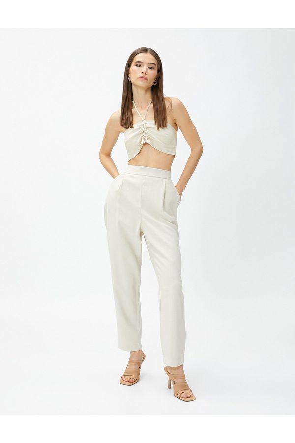 Koton Koton Svilnato teksturirane hlače z elastičnim pasom in žepi.